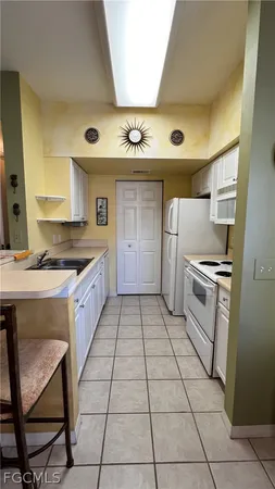 a kitchen with a stove a sink and a refrigerator
