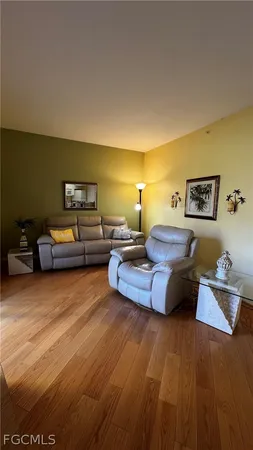 a bedroom with furniture and a wooden floor