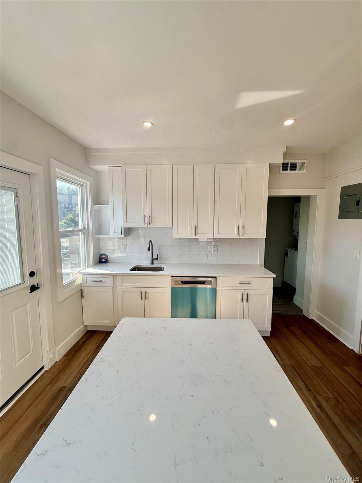 44 Purchase Street, Unit 3L Rye, NY 10580 - Photo 4 of 16 Kitchen featuring white shaker cabinetry, white countertops, wood-finish flooring, a stainless steel dishwasher, and recessed lighting