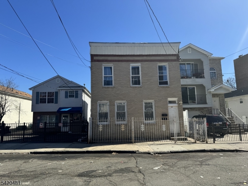 65 Stone Street Newark, NJ 07104 - Photo 1 of 37 a front view of a building with street