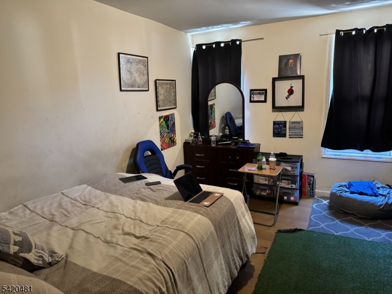 65 Stone Street Newark, NJ 07104 - Photo 15 of 37 a bedroom with a bed and a couch