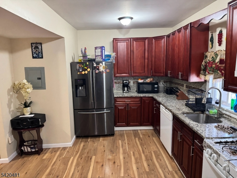 65 Stone Street Newark, NJ 07104 - Photo 21 of 37 a kitchen with stainless steel appliances granite countertop a refrigerator stove top oven and sink