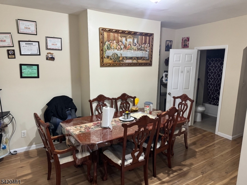 65 Stone Street Newark, NJ 07104 - Photo 24 of 37 a view of a dining room with furniture and wooden floor