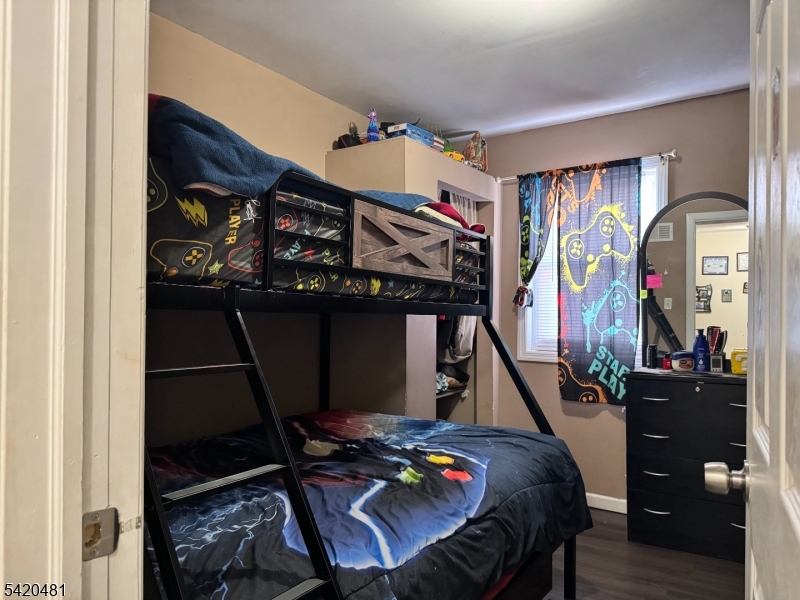65 Stone Street Newark, NJ 07104 - Photo 31 of 37 a bedroom with furniture and wooden floor