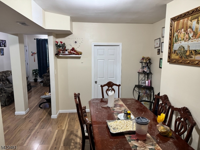 65 Stone Street Newark, NJ 07104 - Photo 36 of 37 a view of a dining room with furniture and wooden floor