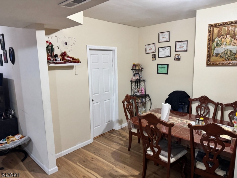 65 Stone Street Newark, NJ 07104 - Photo 37 of 37 a view of a dining room with furniture and wooden floor
