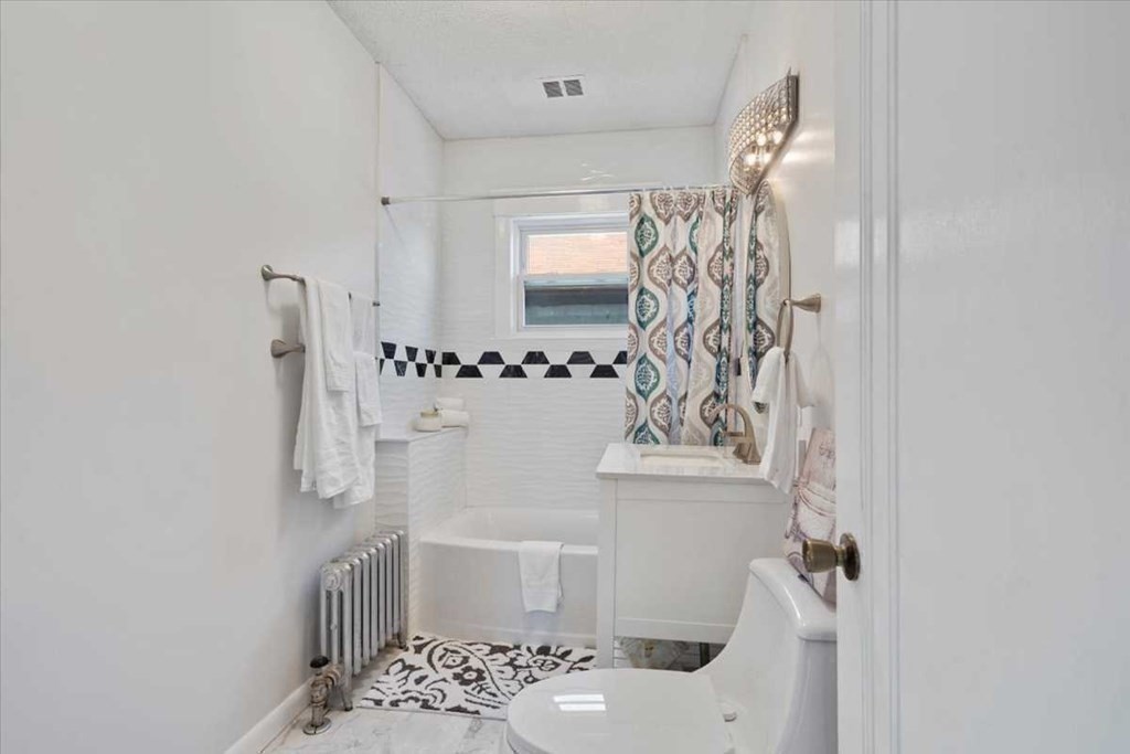 5 Locust Avenue Worcester, MA 01604 - Photo 14 of 40 a bathroom with a sink a toilet and shower curtain