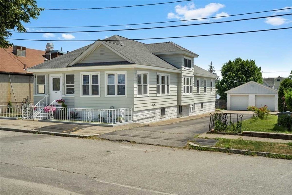 5 Locust Avenue Worcester, MA 01604 - Photo 2 of 40 a front view of a house with a garden
