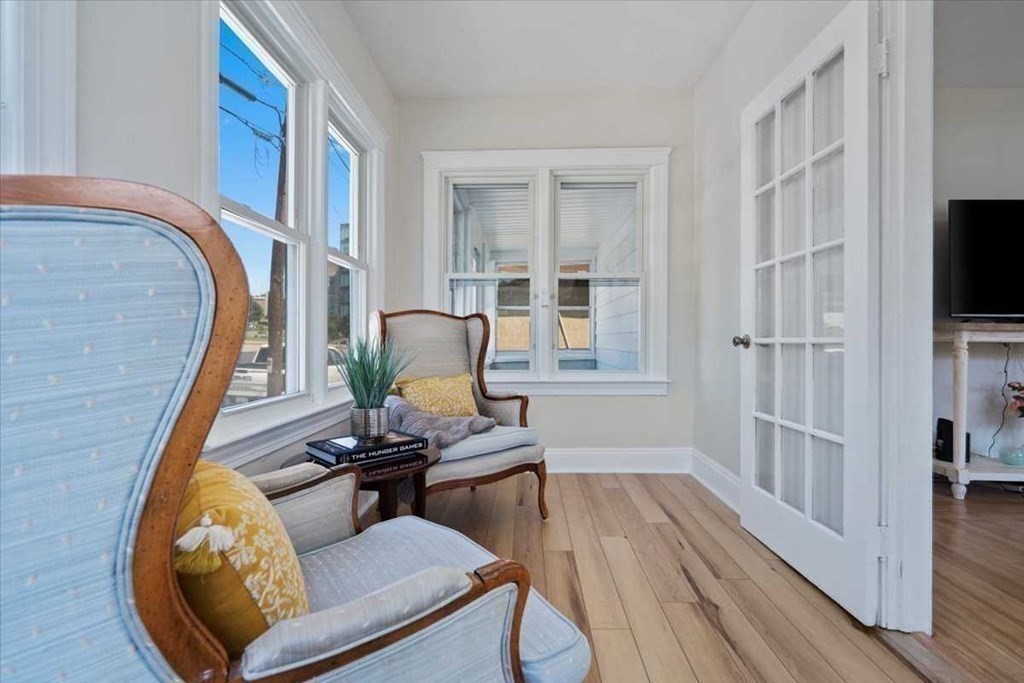 5 Locust Avenue Worcester, MA 01604 - Photo 22 of 40 a view of a livingroom with furniture a fireplace wooden floor and windows