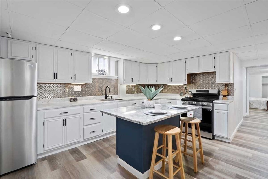 5 Locust Avenue Worcester, MA 01604 - Photo 23 of 40 a kitchen with stainless steel appliances kitchen island granite countertop a sink stove and refrigerator