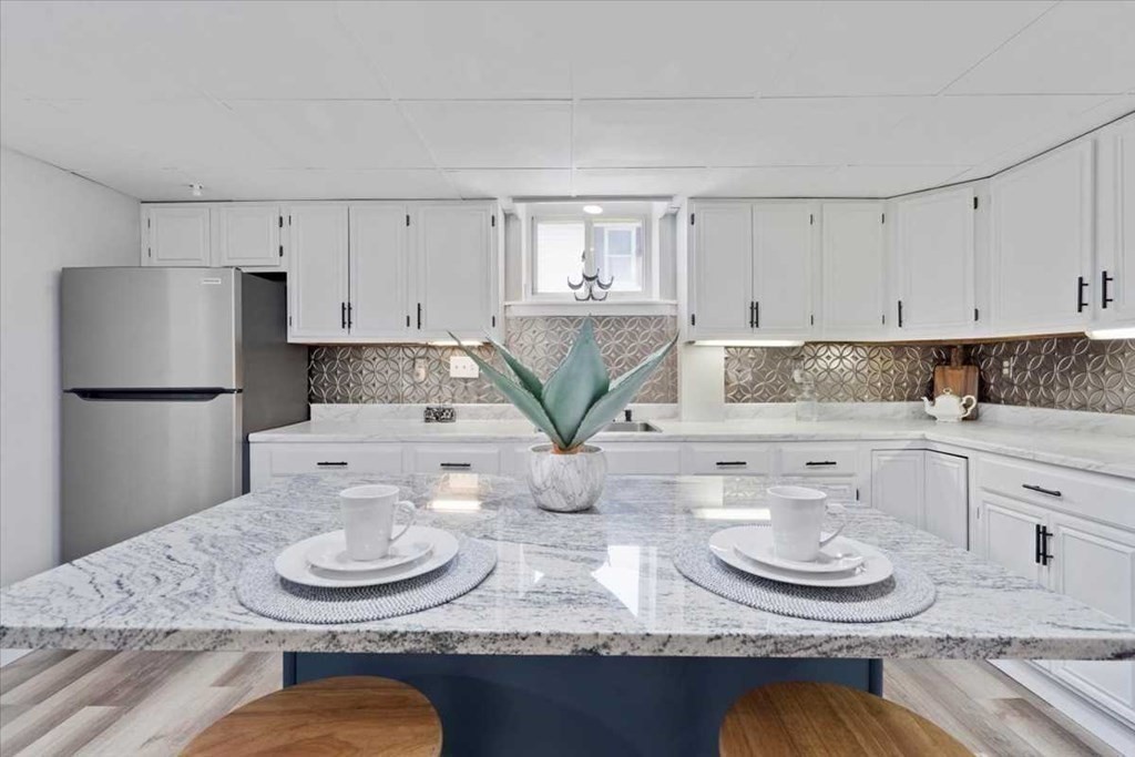 5 Locust Avenue Worcester, MA 01604 - Photo 24 of 40 a kitchen with granite countertop stainless steel appliances a table and chairs