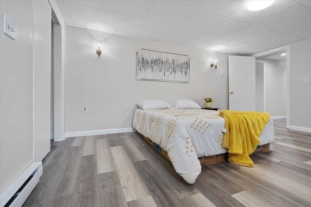 5 Locust Avenue Worcester, MA 01604 - Photo 28 of 40 a bedroom with a bed and wooden floor