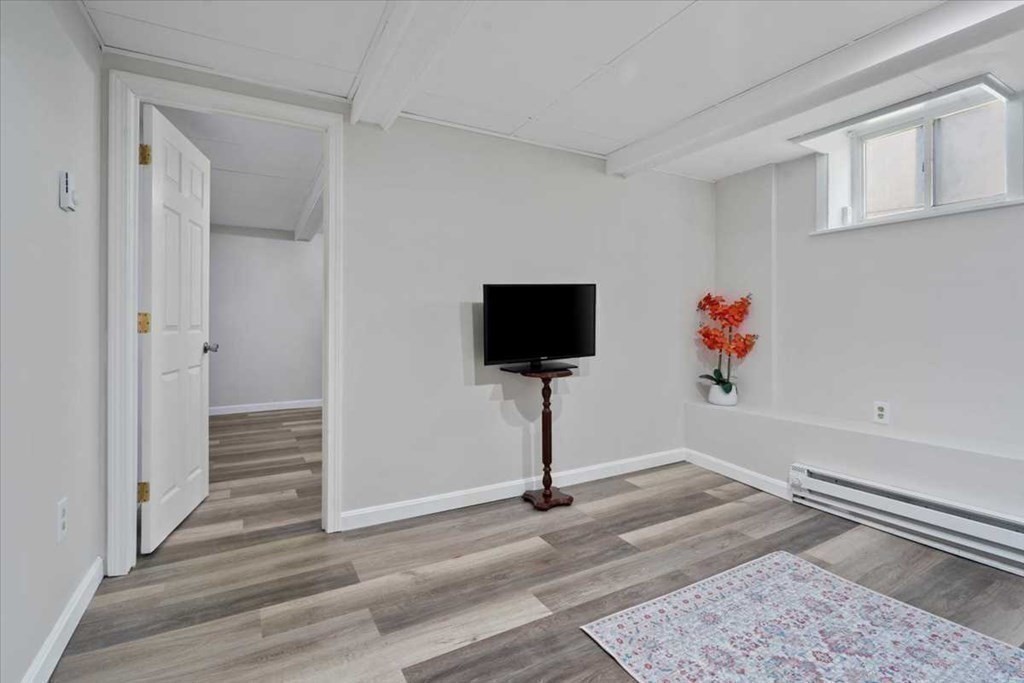 5 Locust Avenue Worcester, MA 01604 - Photo 31 of 40 a view of a livingroom with wooden floor and workspace