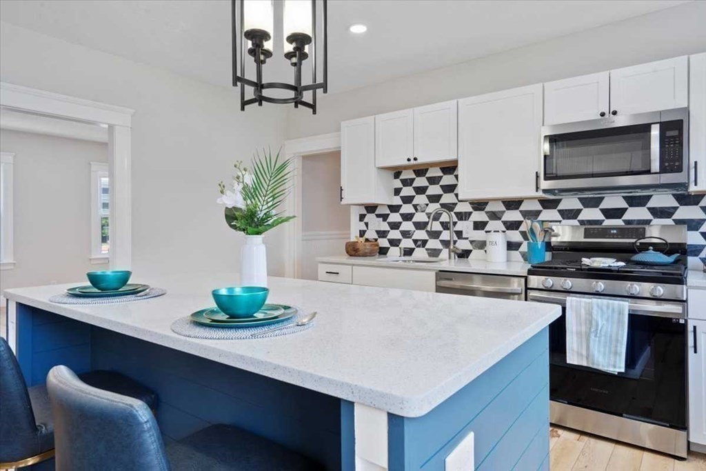 5 Locust Avenue Worcester, MA 01604 - Photo 6 of 40 a kitchen with stainless steel appliances a white table chairs and a stove
