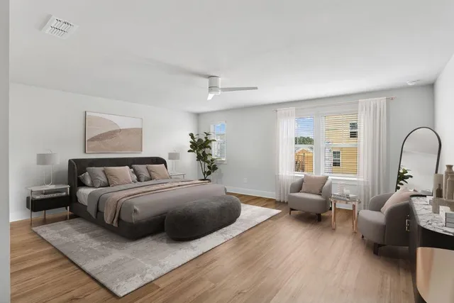 a view of a bedroom with furniture and wooden floor