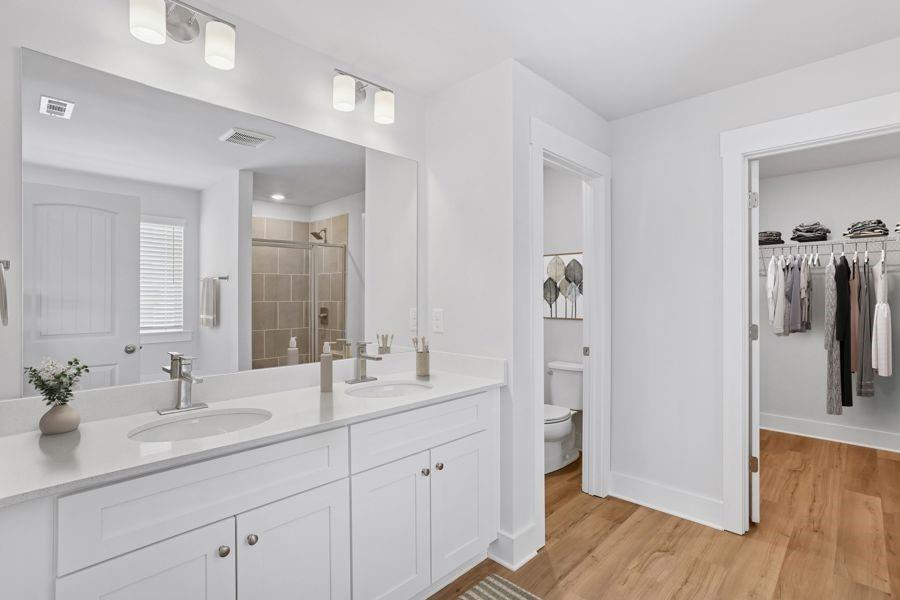 1575 Cedars Road Southeast, Unit MAGNOLIA Lawrenceville, GA 30045 - Photo 7 of 17 a bathroom with a double vanity sink and mirror