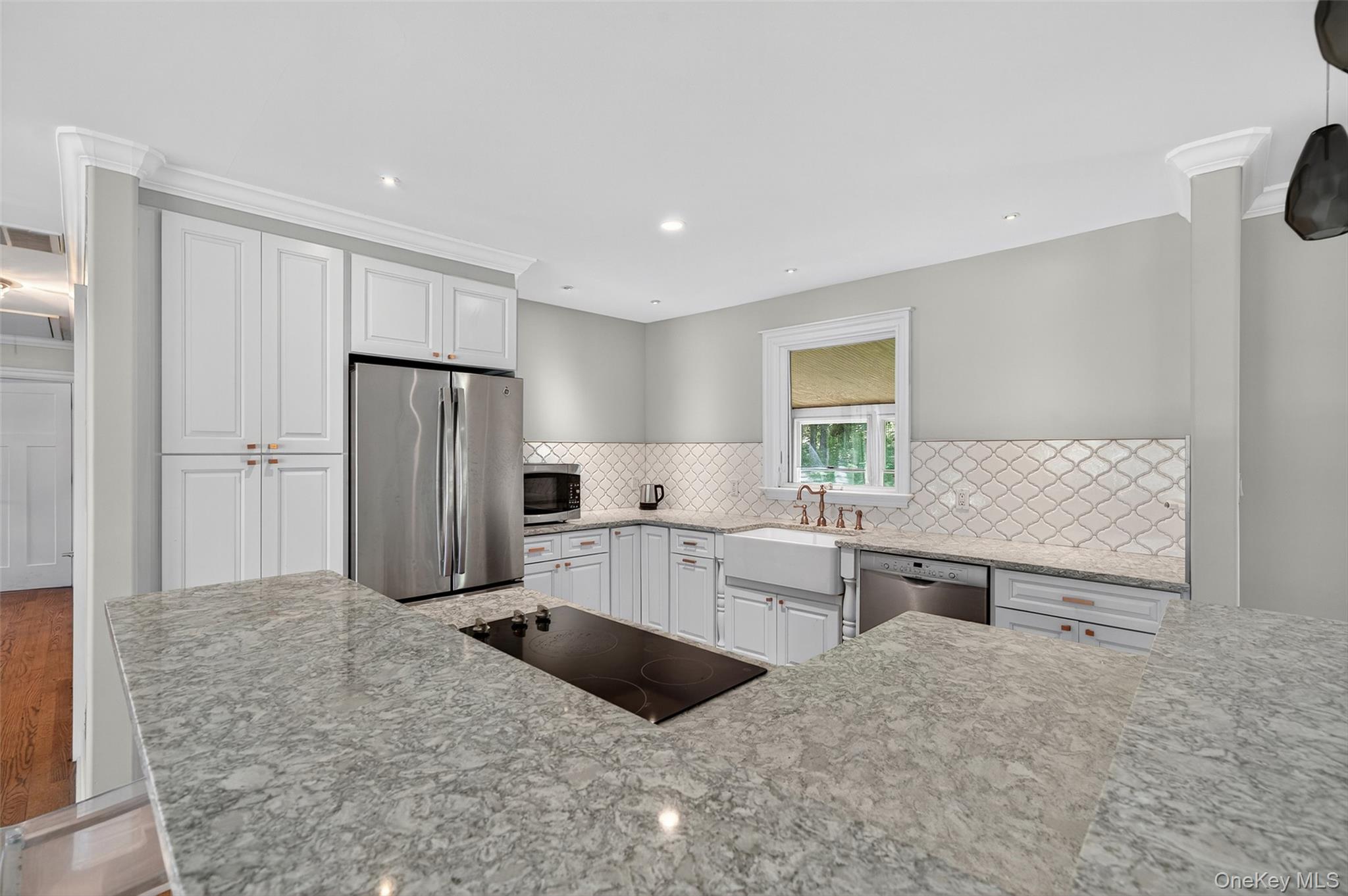 65 Hawxhurst Road Monroe, NY 10950 - Photo 16 of 35 Kitchen with stainless steel appliances, tasteful backsplash, white cabinetry, light stone counters, and recessed lighting