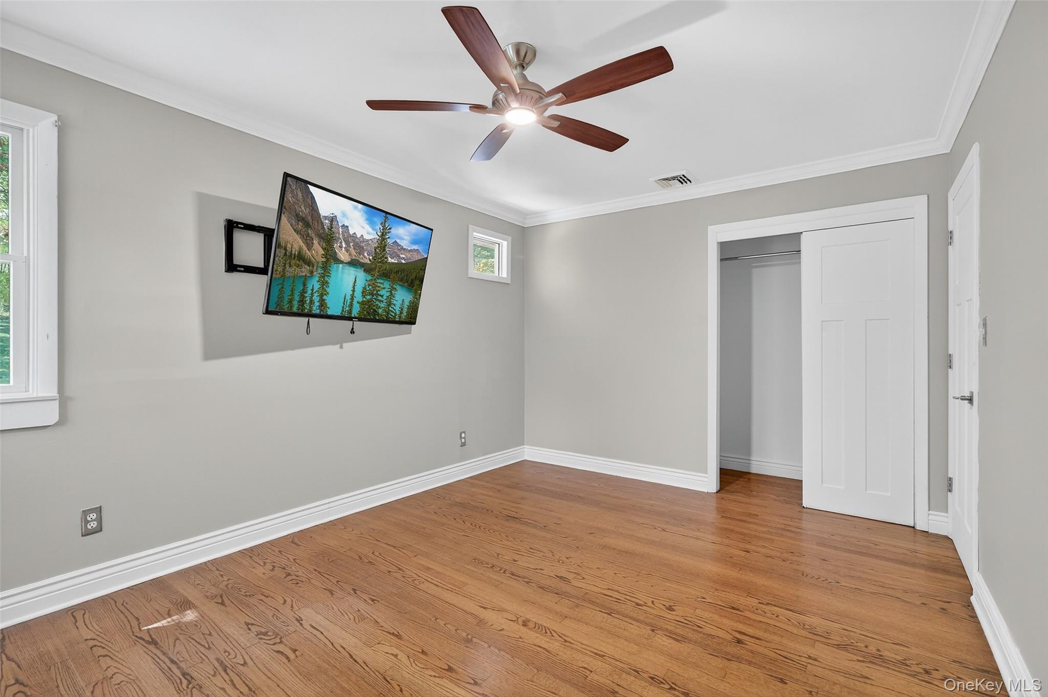 65 Hawxhurst Road Monroe, NY 10950 - Photo 22 of 35 Unfurnished bedroom featuring crown molding, wood finished floors, a closet, and ceiling fan
