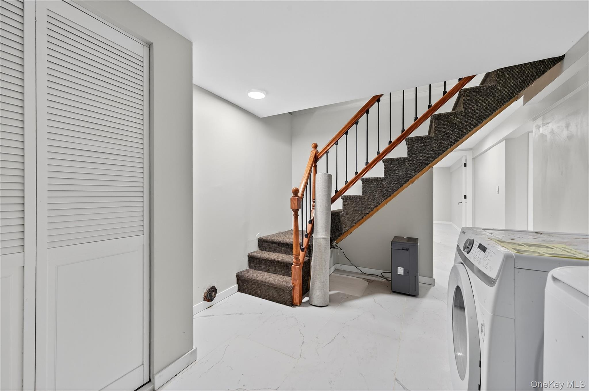 65 Hawxhurst Road Monroe, NY 10950 - Photo 28 of 35 Staircase featuring marble finish floors, washing machine and clothes dryer, and recessed lighting