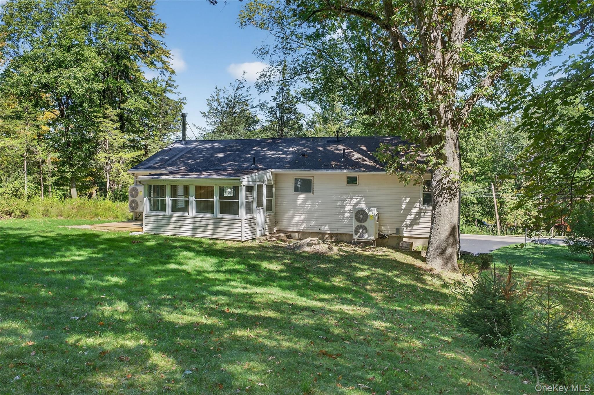 65 Hawxhurst Road Monroe, NY 10950 - Photo 33 of 35 Rear view of property with a sunroom and a lawn