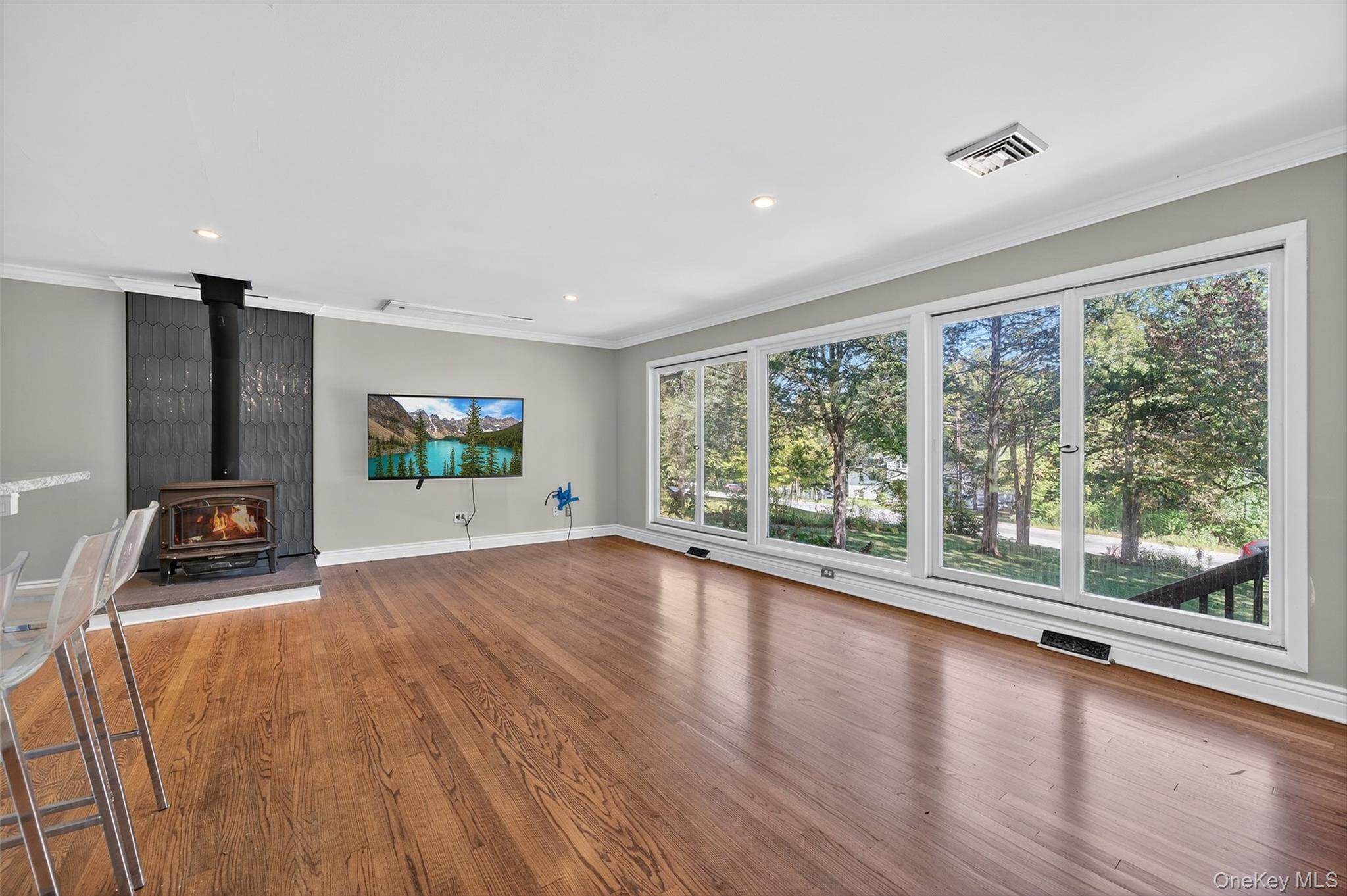 65 Hawxhurst Road Monroe, NY 10950 - Photo 7 of 35 Unfurnished living room featuring a wood stove, ornamental molding, wood finished floors, and recessed lighting