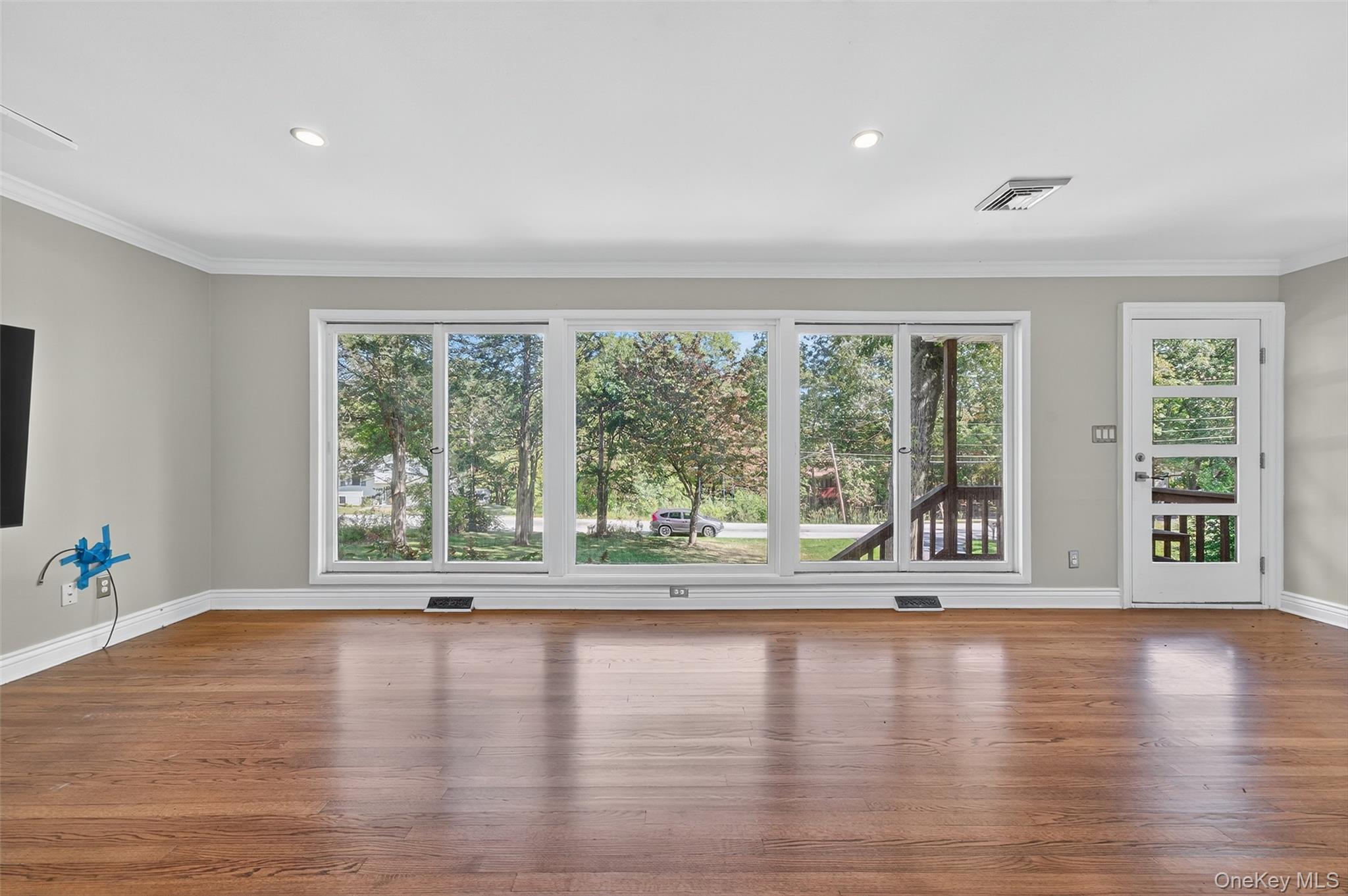 65 Hawxhurst Road Monroe, NY 10950 - Photo 8 of 35 Unfurnished living room with crown molding, plenty of natural light, wood finished floors, and recessed lighting