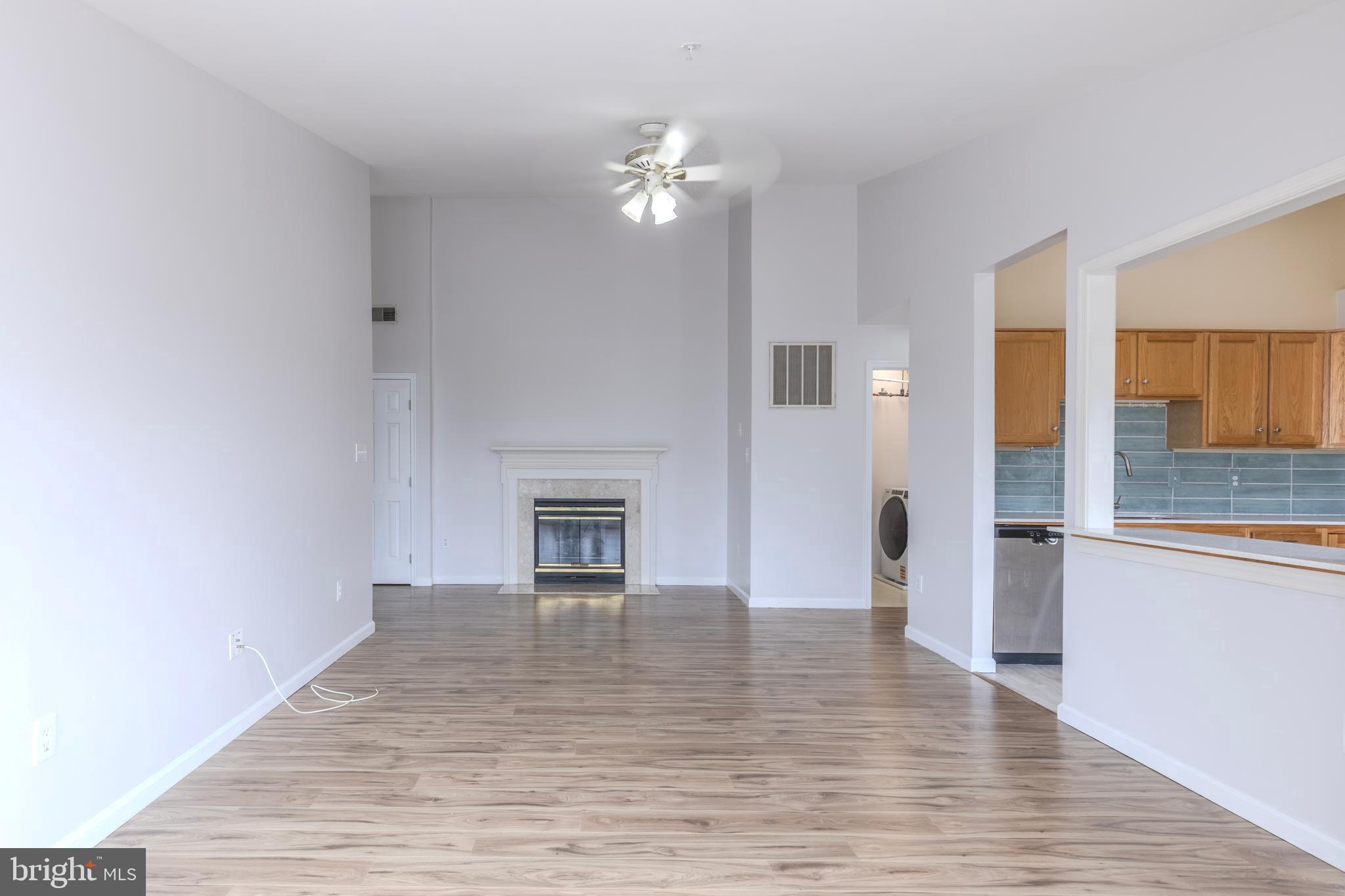 7522 Snowpea Court, Unit 24 Alexandria, VA 22306 - Photo 11 of 19 a view of an empty room with wooden floor and a fireplace