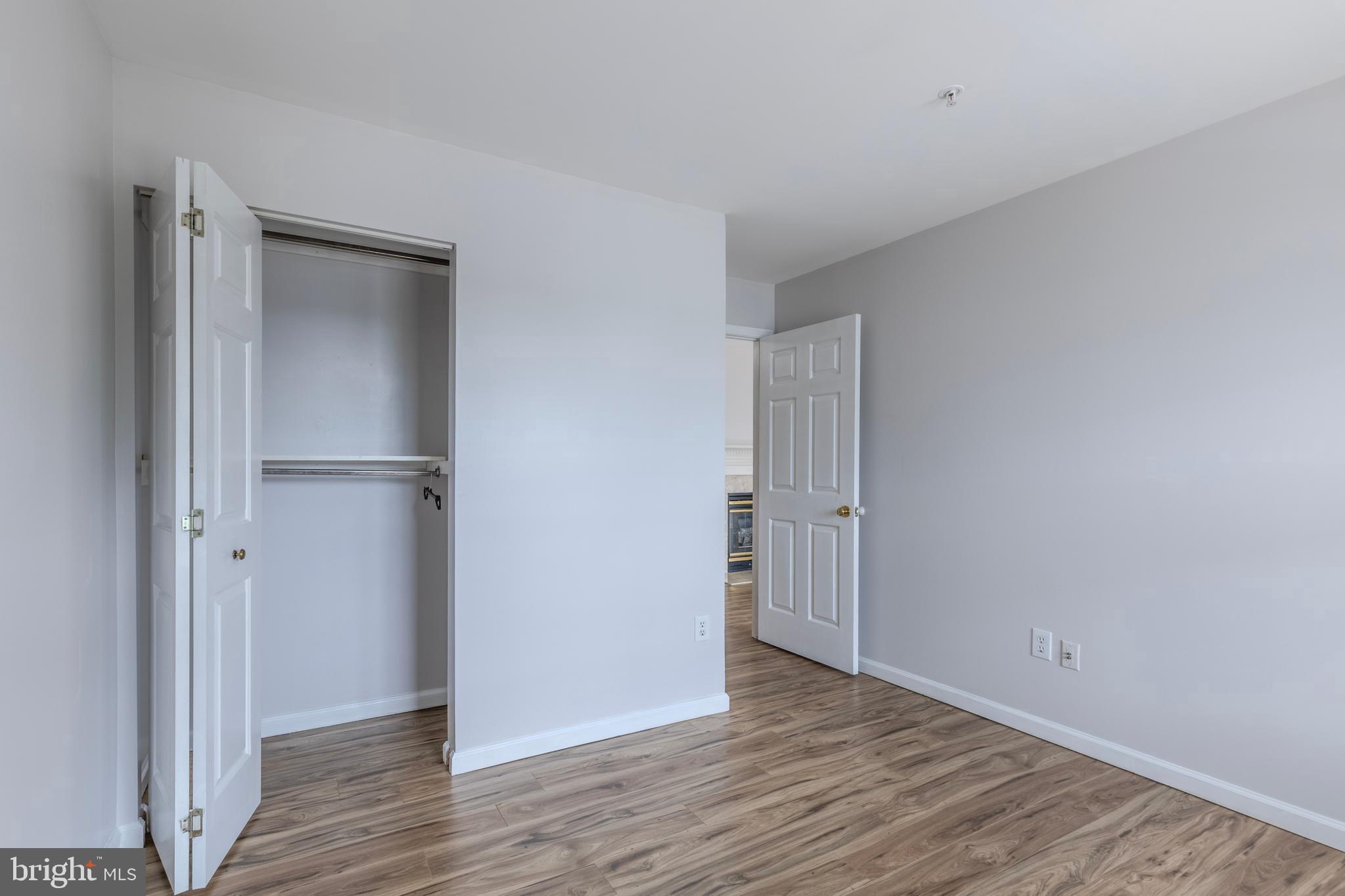 7522 Snowpea Court, Unit 24 Alexandria, VA 22306 - Photo 17 of 19 a view of an empty room with wooden floor & closet