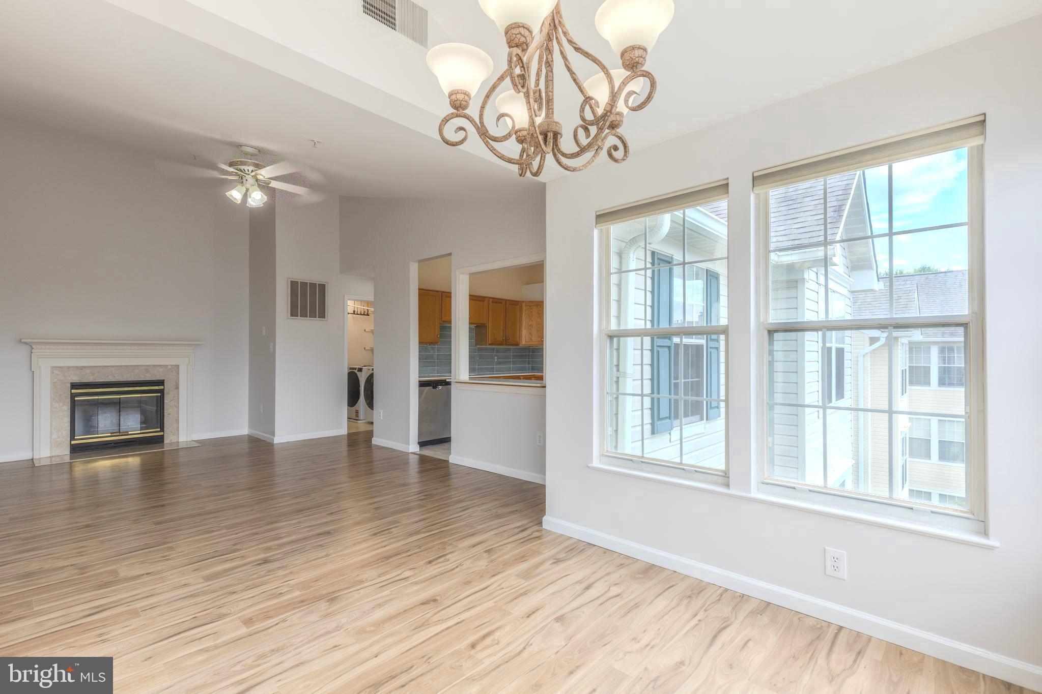 7522 Snowpea Court, Unit 24 Alexandria, VA 22306 - Photo 7 of 19 a view of an empty room with a window and wooden floor