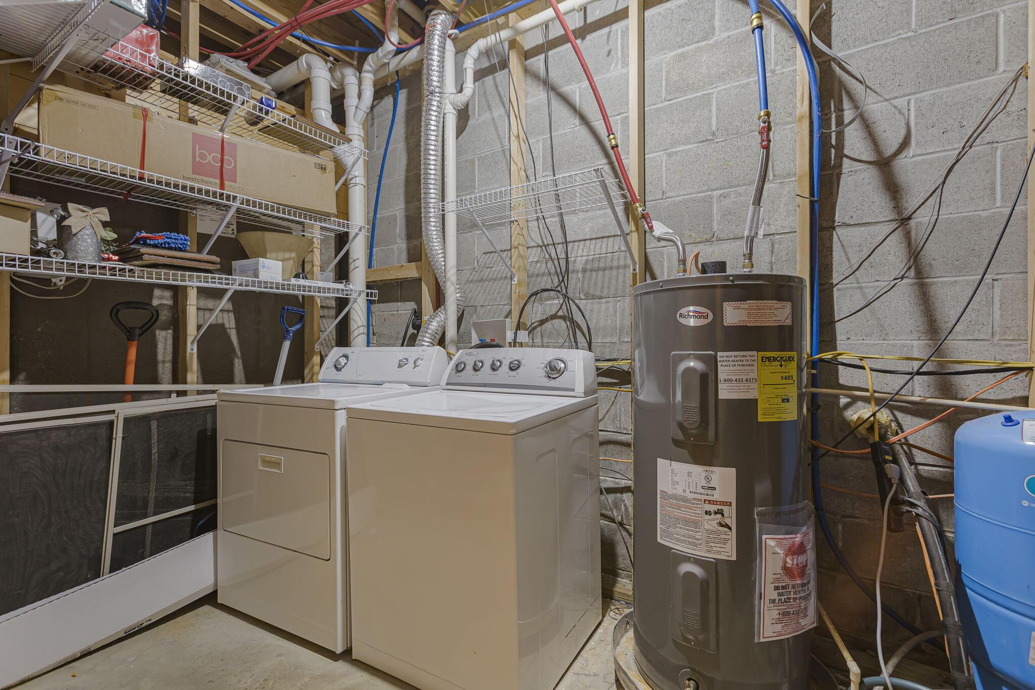 19475 Linden Road Logan, OH 43138 - Photo 49 of 94 Utility space featuring a water heater, washer, and dryer