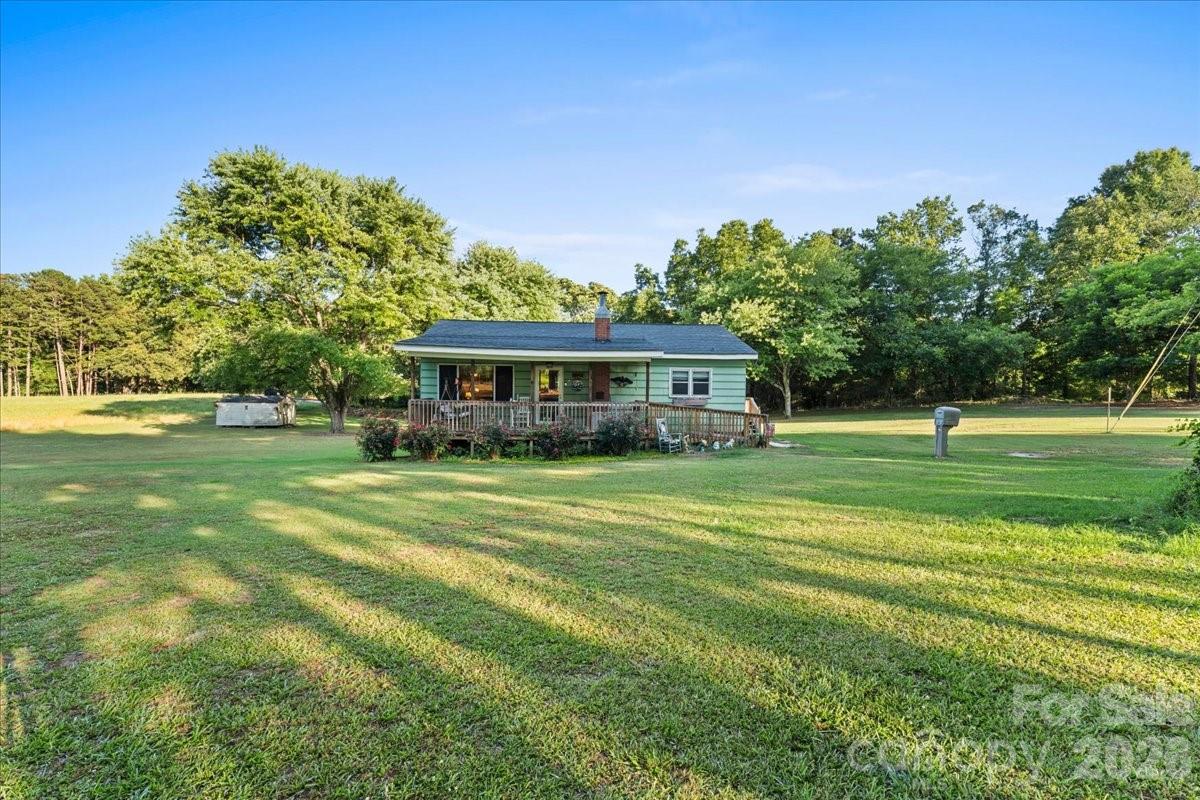 12282 Coyle Road Stanfield, NC 28163 - Photo 14 of 24 a front view of a house with a garden