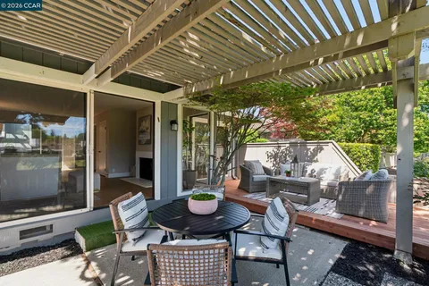 a backyard of a house with fire pit and outdoor seating