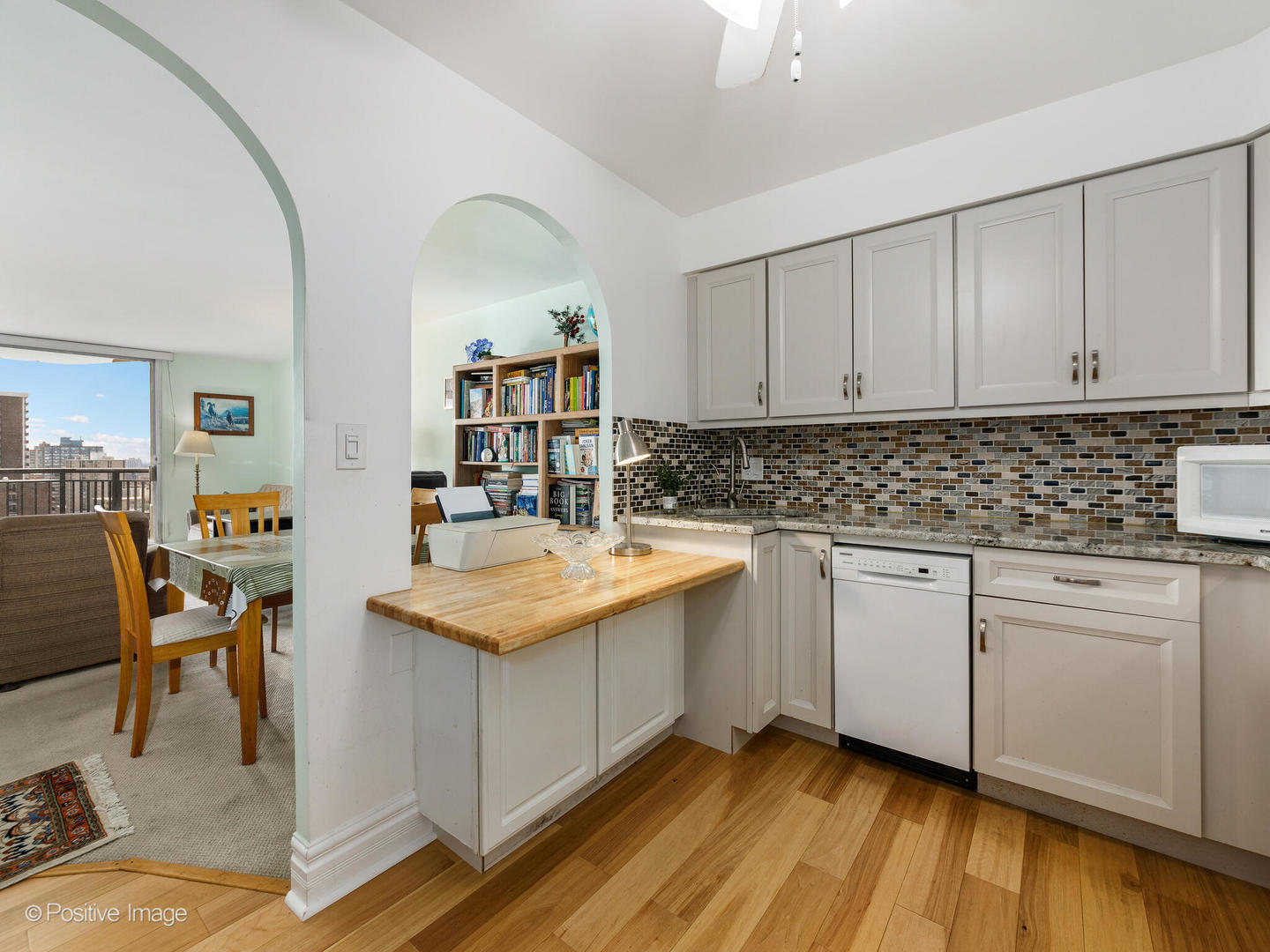 6007 North Sheridan Road, Unit 17G Chicago, IL 60660 - Photo 8 of 18 a kitchen with stainless steel appliances granite countertop a sink stove and cabinets