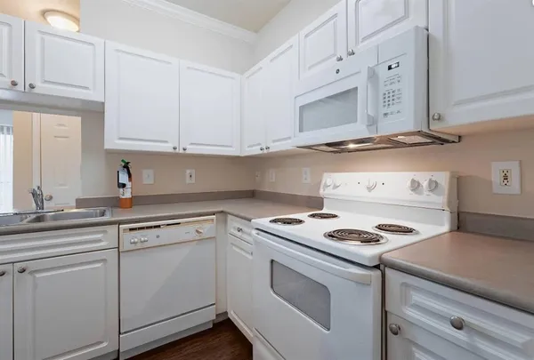 a kitchen with cabinets appliances and a sink