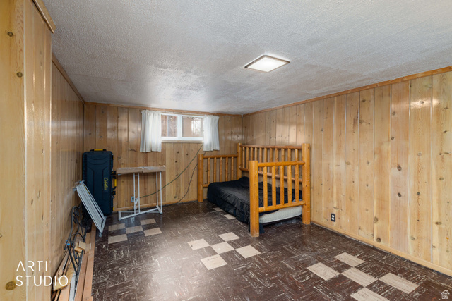 875 Patterson Street Ogden, UT 84403 - Photo 26 of 38 Bedroom with dark flooring and wooden walls