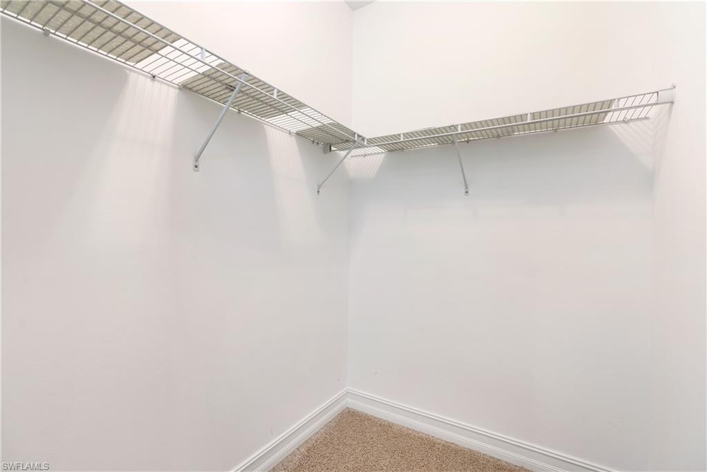 14488 Stillwater Way Naples, FL 34114 - Photo 20 of 36 Walk in closet with carpet flooring