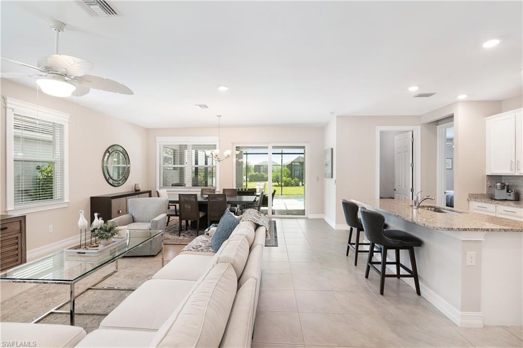 14488 Stillwater Way Naples, FL 34114 - Photo 2 of 36 Living room featuring a chandelier, a ceiling fan, recessed lighting, and light tile patterned floors