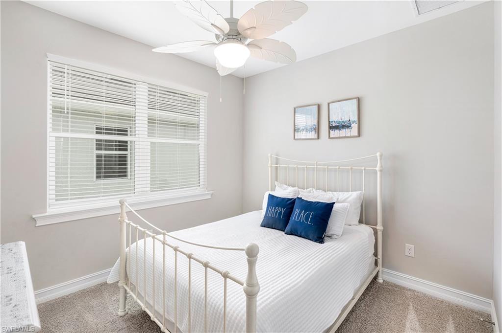 14488 Stillwater Way Naples, FL 34114 - Photo 24 of 36 Carpeted bedroom featuring a ceiling fan and baseboards