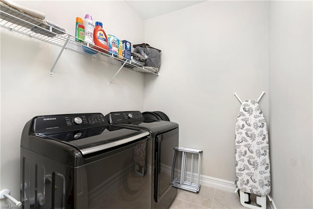 14488 Stillwater Way Naples, FL 34114 - Photo 25 of 36 Laundry area featuring light tile patterned floors and washing machine and dryer