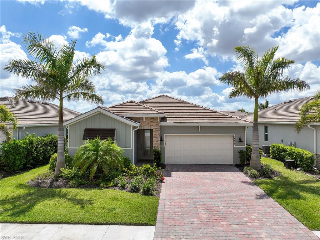 14488 Stillwater Way Naples, FL 34114 - Photo 36 of 36 Single story home featuring a front yard, stone siding, a tile roof, and decorative driveway