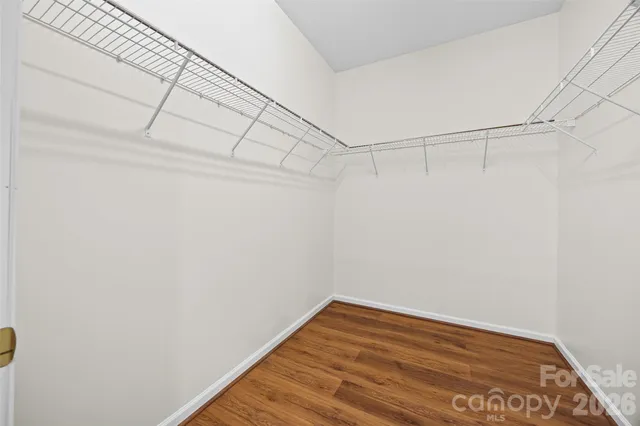 a bathroom with a double vanity sink a toilet a mirror and shower