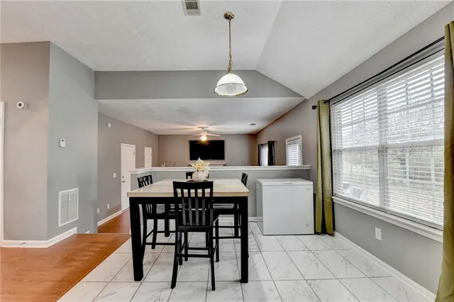 a view of a dining room with furniture window and wooden floor