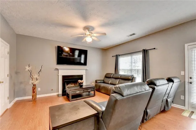 a living room with furniture flat screen tv and a fireplace