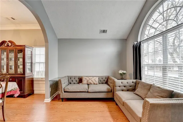 a bedroom with a bed and a flat tv screen on a dresser