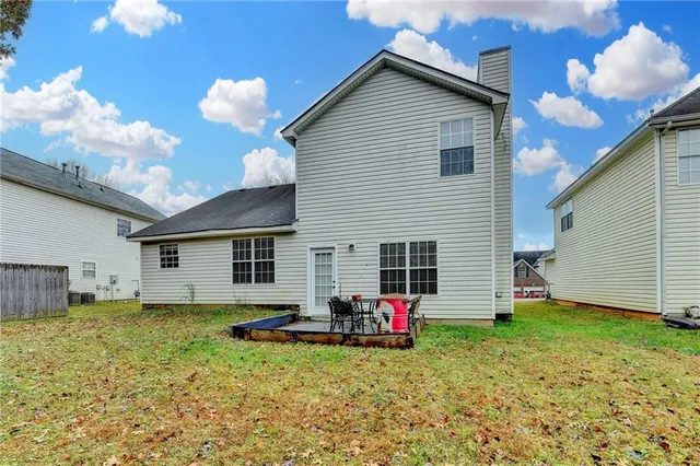 an aerial view of a house with outdoor space and a lake view