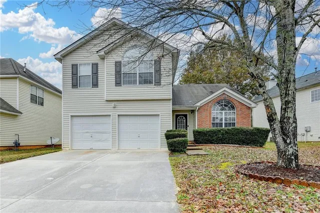 a view of a livingroom with furniture hardwood floor and a large window