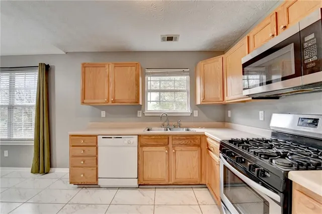 a kitchen with stainless steel appliances granite countertop a stove and a sink