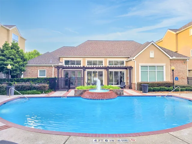 a view of house with swimming pool outdoor seating