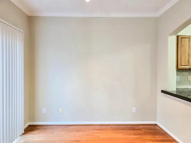 a view of small space with wooden floor and a window