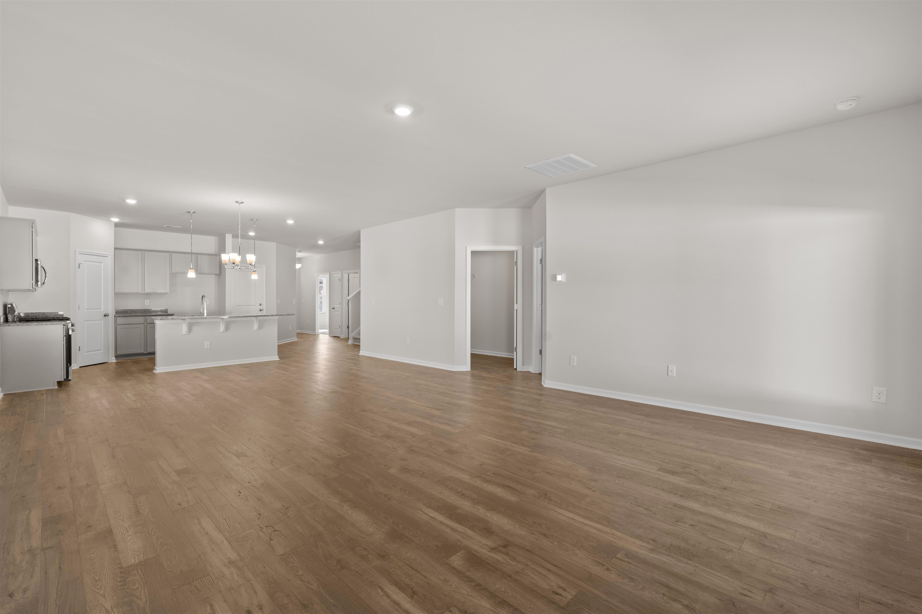 2491 Campton Loop Conway, SC 29527 - Photo 25 of 38 Unfurnished living room with recessed lighting, dark wood-style flooring, and a chandelier
